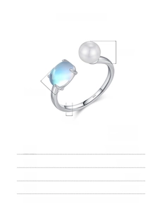 Macro detail of S925 sterling silver ring with 6mm pearl and oval blue gemstone
