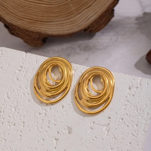 Exaggerated geometric gold layered oval hoop earrings on stone display for women