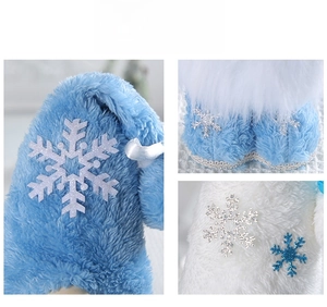 Macro detail of blue faux fur and sparkling snowflake patterns on Christmas gnome decor