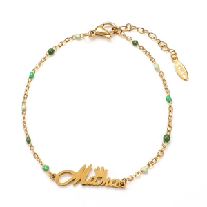 Detail of gold stainless steel mama bracelet with green beads and crown charm
