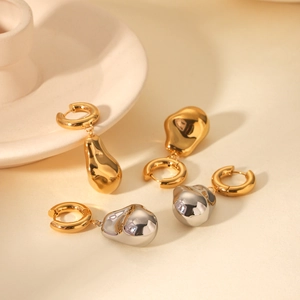 Detailed view of fluid-style 18K gold and silver baroque molten metal drop earrings