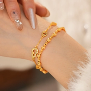 Detail of 24k gold plated bracelet with gourd charms and sparkling zircon inlays