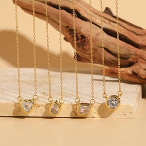 Minimalist gold zircon necklaces featuring heart, teardrop, square and round pendants