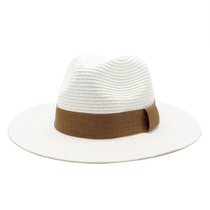 Close-up of white woven straw Panama hat with a contrasting dark brown decorative ribbon