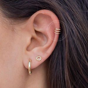 Minimalist 18k gold ear cuff set with multi-layer hollow design on model ear