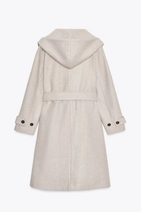 Close-up of oatmeal wool blend hooded coat featuring waist belt and button cuff details