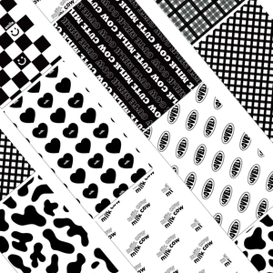 Detail of 8 black and white aesthetic stickers with cow print and checkerboard patterns