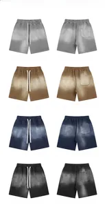 Dettaglio di pantaloncini da uomo tinti a spruzzo in grigio, marrone, blu e nero