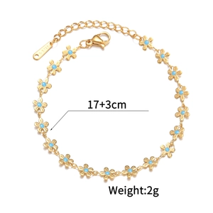 Detailed view of 18K gold flower bracelet with blue centers and size parameters