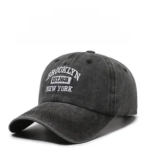 Detail of vintage washed baseball cap with white Brooklyn embroidery on grey cotton