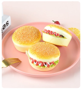 Macro shot of three artificial PU foam burgers with sesame details and lettuce layers