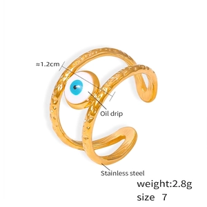 Detail of evil eye ring in gold plated stainless steel with blue oil drip texture