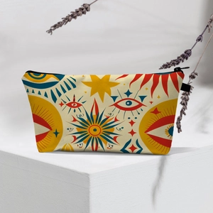 Close-up of bohemian evil eye makeup bag on a geometric stand with lavender accents