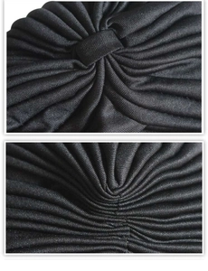 Detail of black turban hat showing soft pleated texture and elastic knit fabric