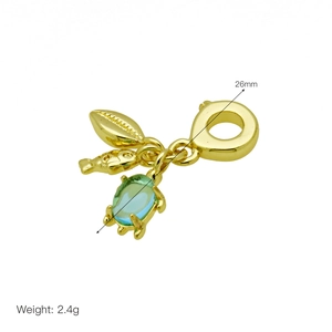 Detailed view of turtle and leaf charms on a golden bead with 26mm total length