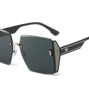 Fashionable rimless oversized black sunglasses with dark gray lenses and silver trim