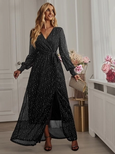 Detail of elegant black polka dot V-neck maxi dress with long sleeves and high slit design