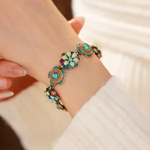 Vintage floral enamel bracelet in gold with colorful rhinestones and intricate petal details