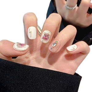 Baroque butterfly press-on nails in milky white with dried flower art and gold accents