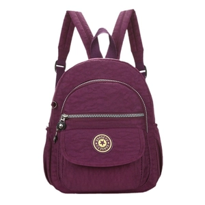 Minimalist purple nylon travel backpack with adjustable straps and front zip pocket
