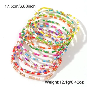 Colorful mixed seed bead layered bracelet set featuring boho style and gold bead accents