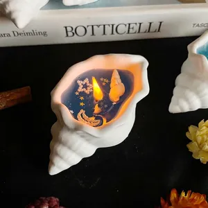 Artistic seashell scented candle with deep blue wax and ocean star decorations