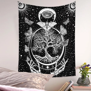 Detail of black and white mystic tapestry featuring Tree of Life, eye, and moon phases