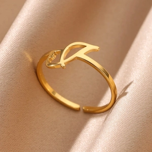 Macro shot of adjustable gold stainless steel ring with Arabic calligraphy on silk
