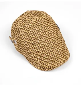 Detail of zigzag woven texture on brown straw flat cap with breathable visor finish
