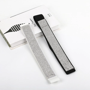 Close-up of black and white elastic waist belts with shimmering silver rhinestones