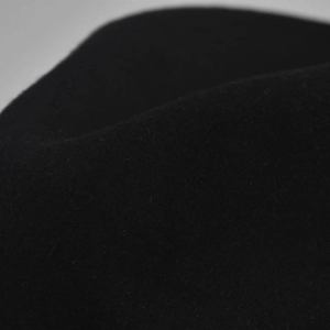Close-up detail of premium thick black wool felt fabric with soft textured finish
