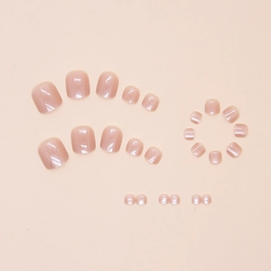 Detail of nude pink cat eye press-on toenails with shimmering finish and smooth texture