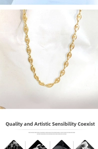 Close-up of gold 18K plated coffee bean link necklace on white fabric texture background