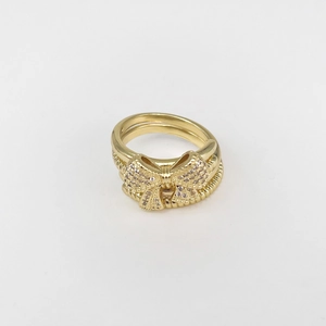 Macro detail of gold-plated multi-layer ring with sparkling cubic zirconia butterfly bow