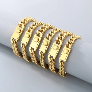 Five gold Cuban chain bracelets with square clasps displayed on a grey cylinder