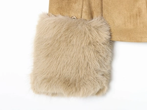 Detailed close-up of fuzzy faux fur cuffs and suede texture on a camel blazer jacket