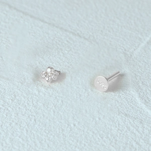 Macro shot of S925 sterling silver flat back stud earrings with pearls and clear stones