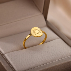 Detailed close-up of 18K gold sun engraved ring presented in a premium jewelry box