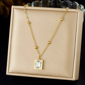 Gold-plated geometric pendant necklace with rectangular crystal on champagne silk base