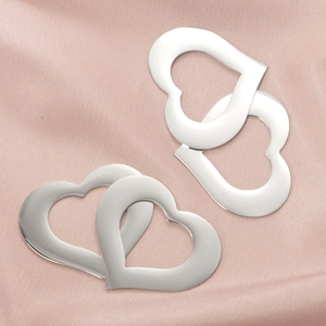 Hollow heart stainless steel pendants for DIY jewelry on pink silk background