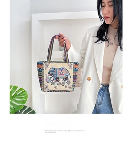 Ethnic canvas tote bag featuring intricate elephant embroidery with colorful patterns