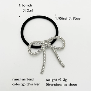 Detailed view of the gold bow hairband showing its metal texture and dimension specs