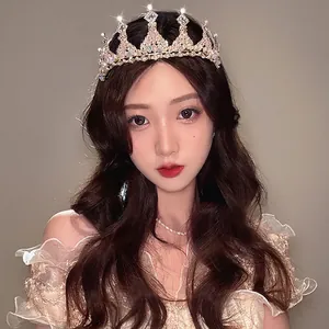 Elegant gold birthday crown with rhinestones shown on model for bride or princess party