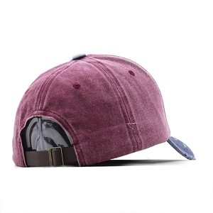 Detail of vintage washed cotton baseball cap with brown leather strap and metal buckle