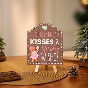 Close-up of wooden gingerbread man holiday sign on tripod stand with festive decor