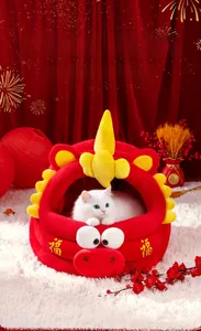 Detail of plush Year of the Dragon cat bed with golden festive embroidery and yellow horns