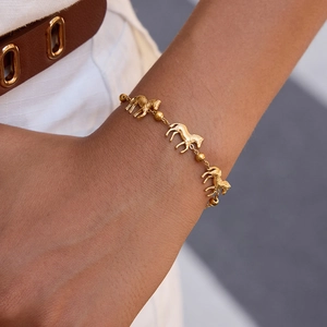 Detail view of 18k gold plated titanium steel bracelet with zebra pattern horse charms