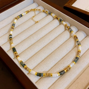 Square aquamarine pearl necklace with green and grey beads in a jewelry display box