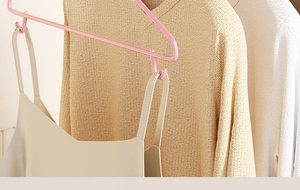 Detailed close-up of pink non-slip hanger with side hooks for camisoles and knits