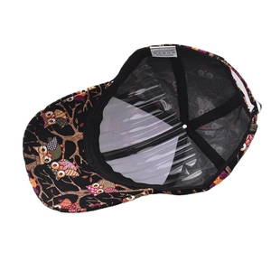 Detail of printed baseball cap interior with owl pattern and 100% polyester label
